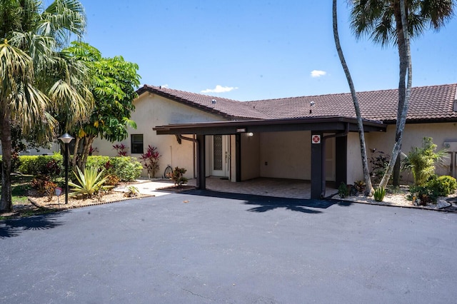 21188 Juego Cir Unit 17-A, Boca Raton, FL 33433 - rear view of house featuring stucco siding and a tiled roof