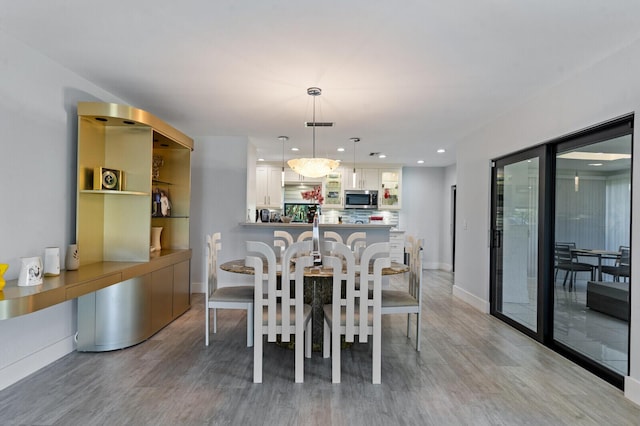 21188 Juego Cir Unit 17-A, Boca Raton, FL 33433 - dining room featuring light wood-type flooring, recessed lighting, and baseboards