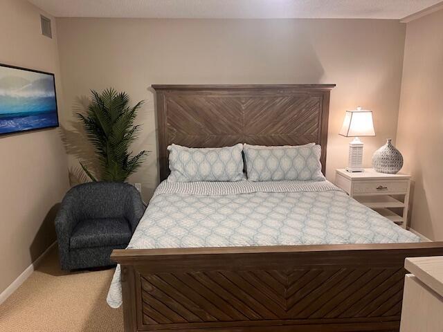 bedroom featuring carpet floors and baseboards