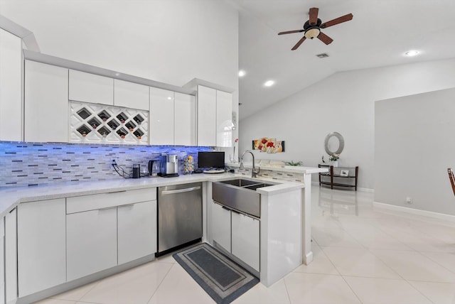 8237 Via Di Veneto, Boca Raton, FL 33496 - kitchen featuring stainless steel dishwasher, a sink, a peninsula, lofted ceiling, and white cabinets