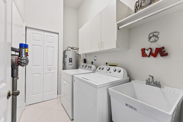 8237 Via Di Veneto, Boca Raton, FL 33496 - laundry area featuring electric water heater, cabinet space, washing machine and dryer, and light tile patterned floors