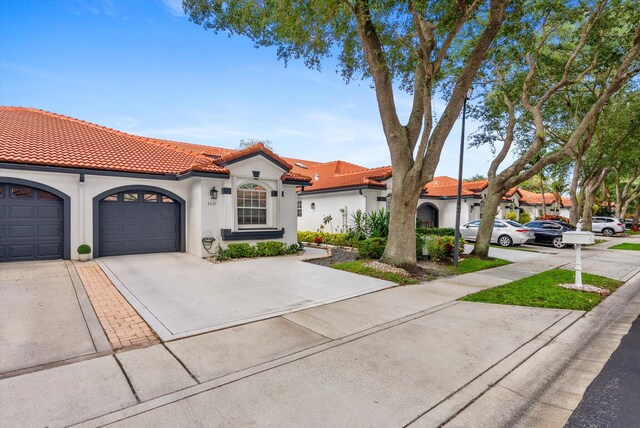 8237 Via Di Veneto, Boca Raton, FL 33496 - mediterranean / spanish-style home featuring concrete driveway, stucco siding, an attached garage, and a tile roof