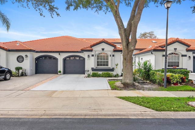 8237 Via Di Veneto, Boca Raton, FL 33496 - mediterranean / spanish house featuring a garage, stucco siding, concrete driveway, and a tiled roof