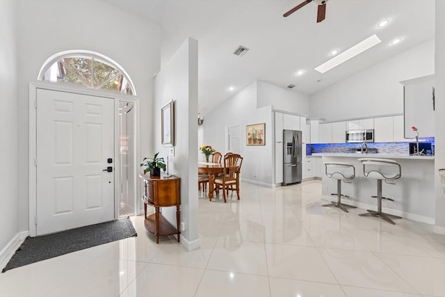8237 Via Di Veneto, Boca Raton, FL 33496 - foyer with a ceiling fan, high vaulted ceiling, baseboards, recessed lighting, and light tile patterned floors