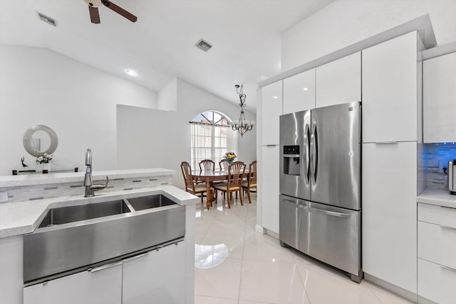 8237 Via Di Veneto, Boca Raton, FL 33496 - kitchen featuring stainless steel fridge, vaulted ceiling, white cabinets, modern cabinets, and ceiling fan