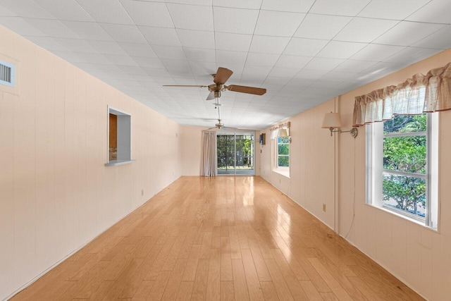 unfurnished room with light wood finished floors and ceiling fan