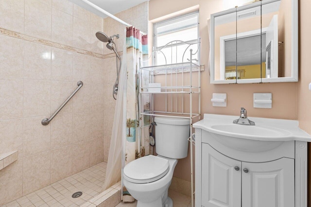 full bathroom with toilet, a shower stall, and vanity