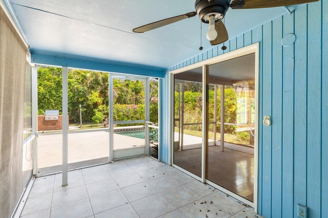 unfurnished sunroom with a ceiling fan
