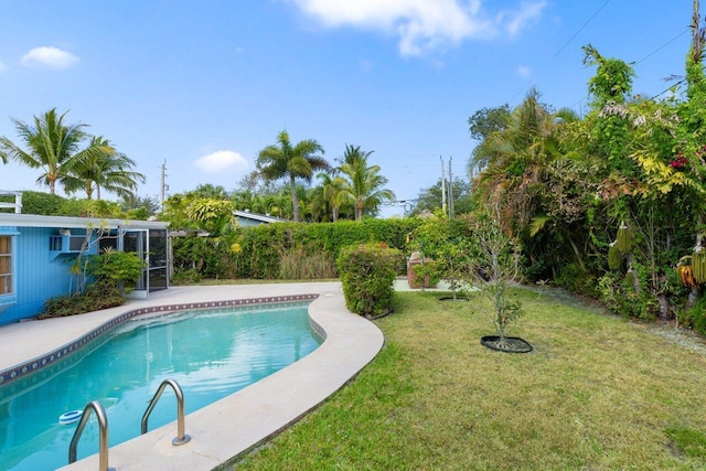 outdoor pool featuring a lawn