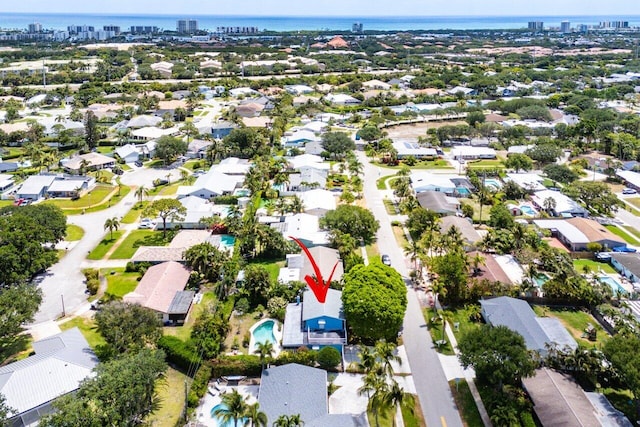 aerial view of property and surrounding area with a nearby body of water, nearby urban area, and nearby suburban area
