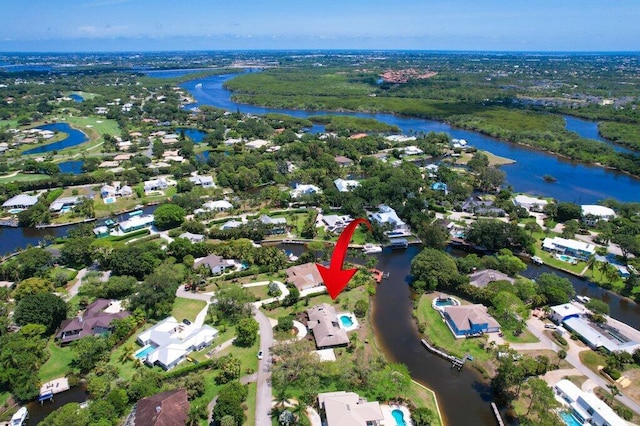 aerial view of property's location with a large body of water and nearby suburban area