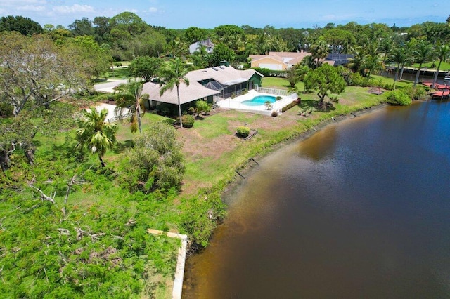 drone / aerial view of a nearby body of water and a pool area