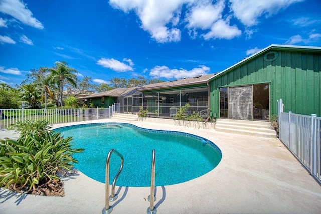 view of swimming pool with a patio and fence