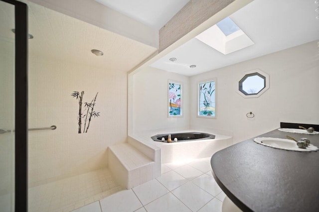full bath with a skylight, a garden tub, tile patterned flooring, and a shower