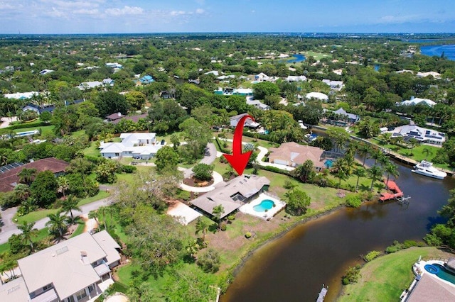 view of property location with a nearby body of water and nearby suburban area