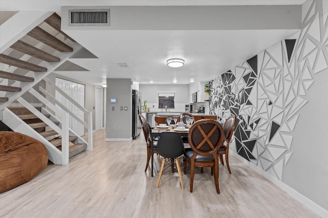 184 NW 115th Ter, Plantation, FL 33325 - dining area with light wood-type flooring, stairway, and baseboards