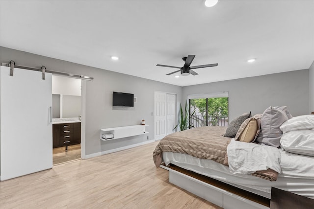 184 NW 115th Ter, Plantation, FL 33325 - bedroom featuring light wood-style flooring, a barn door, recessed lighting, ensuite bath, and a closet