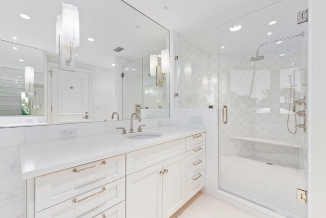 bathroom featuring a stall shower, vanity, and recessed lighting