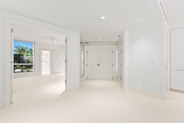 hall featuring recessed lighting and light colored carpet