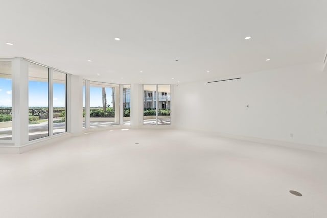 unfurnished room featuring recessed lighting and floor to ceiling windows