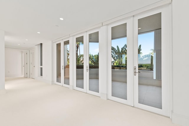entryway with french doors, recessed lighting, and carpet flooring