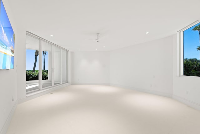 spare room with recessed lighting, ceiling fan, and baseboards