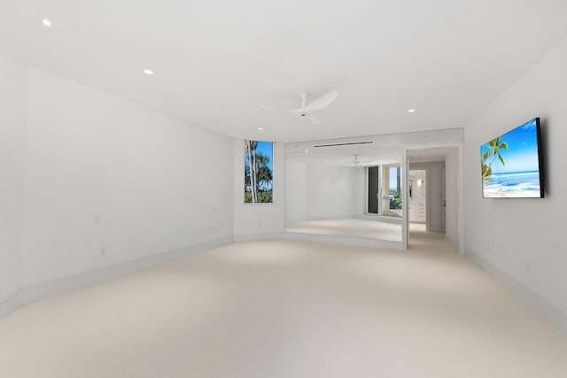 unfurnished room featuring recessed lighting, light carpet, and baseboards