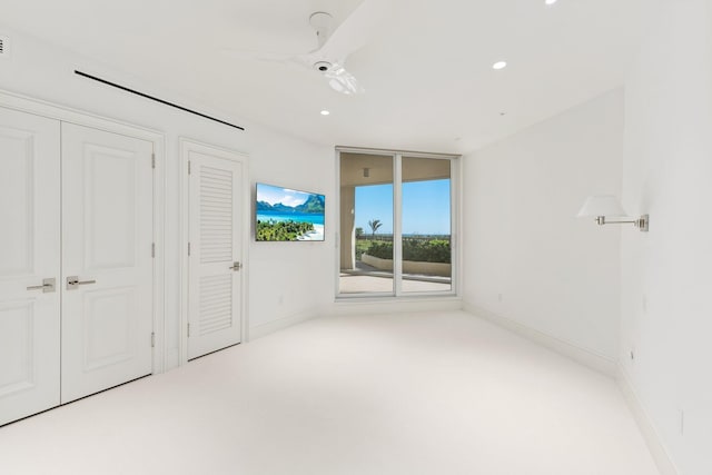 unfurnished bedroom featuring recessed lighting, a ceiling fan, baseboards, and carpet