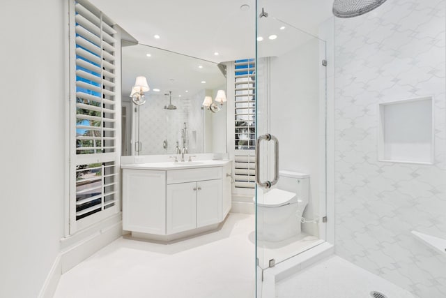 bathroom featuring wallpapered walls, a shower stall, recessed lighting, vanity, and toilet
