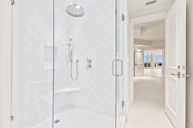bathroom featuring a marble finish shower