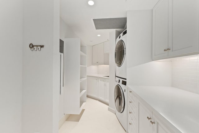 washroom featuring stacked washer / dryer, cabinet space, recessed lighting, and light colored carpet