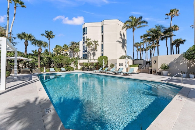 community pool with a patio and stairway