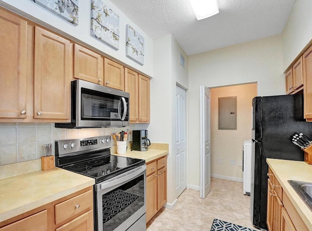 9857 Baywinds Dr Unit 9302, West Palm Beach, FL 33411 - kitchen featuring appliances with stainless steel finishes, electric panel, decorative backsplash, light countertops, and a textured ceiling