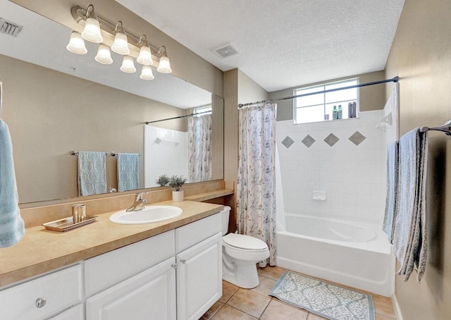 9857 Baywinds Dr Unit 9302, West Palm Beach, FL 33411 - bathroom with tile patterned floors, toilet, shower / bath combination with curtain, vanity, and a textured ceiling