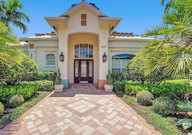 9857 Baywinds Dr Unit 9302, West Palm Beach, FL 33411 - doorway to property featuring french doors, stucco siding, and a tiled roof