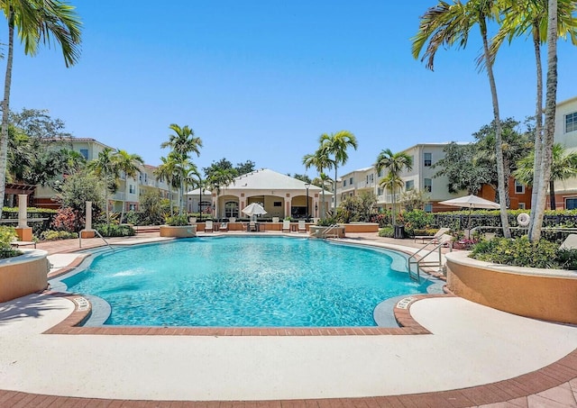 9857 Baywinds Dr Unit 9302, West Palm Beach, FL 33411 - community pool featuring a patio area and a residential view