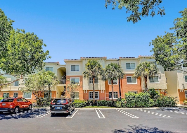 9857 Baywinds Dr Unit 9302, West Palm Beach, FL 33411 - view of building exterior featuring uncovered parking