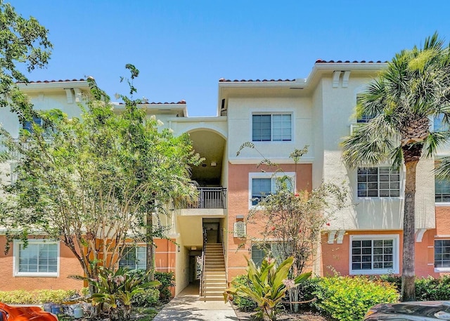 9857 Baywinds Dr Unit 9302, West Palm Beach, FL 33411 - view of front facade with stucco siding and stairs