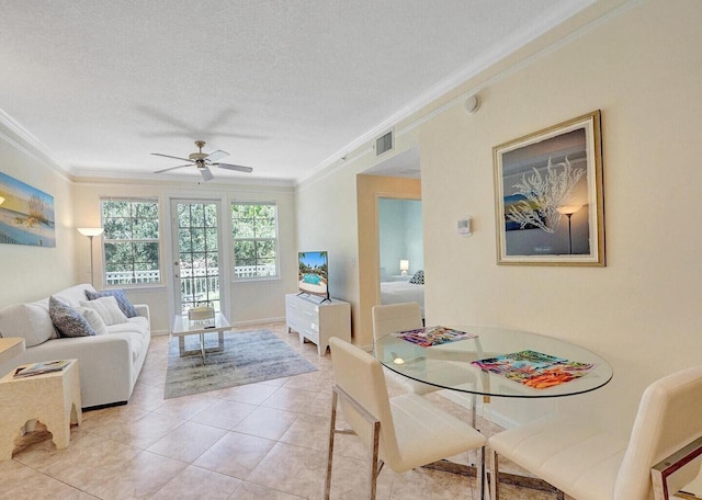 9857 Baywinds Dr Unit 9302, West Palm Beach, FL 33411 - dining room featuring crown molding, ceiling fan, light tile patterned floors, and a textured ceiling