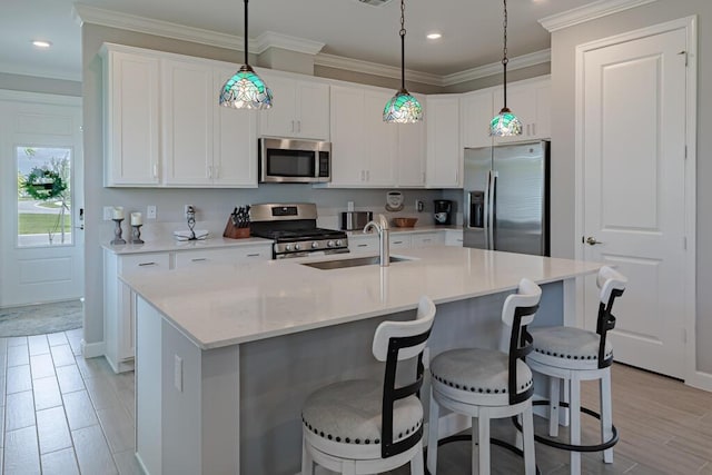 745 SE Bloomfield Rd, Port Saint Lucie, FL 34984 - kitchen featuring appliances with stainless steel finishes, a sink, recessed lighting, a kitchen breakfast bar, and white cabinets
