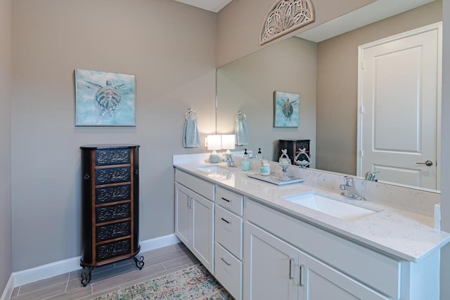 745 SE Bloomfield Rd, Port Saint Lucie, FL 34984 - full bath with baseboards, double vanity, and wood finish floors