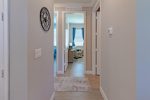 745 SE Bloomfield Rd, Port Saint Lucie, FL 34984 - hallway featuring light wood finished floors, baseboards, and ornamental molding