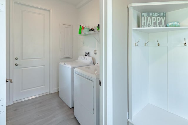 745 SE Bloomfield Rd, Port Saint Lucie, FL 34984 - clothes washing area featuring washer and dryer and light wood-style flooring
