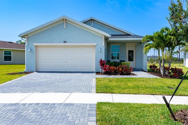 745 SE Bloomfield Rd, Port Saint Lucie, FL 34984 - single story home with decorative driveway, stucco siding, and an attached garage