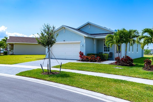 745 SE Bloomfield Rd, Port Saint Lucie, FL 34984 - ranch-style house featuring an attached garage, driveway, a front lawn, and stucco siding