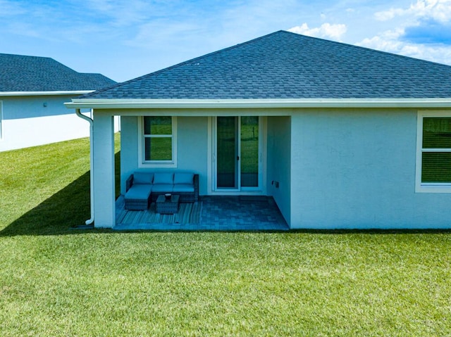 745 SE Bloomfield Rd, Port Saint Lucie, FL 34984 - back of property with a shingled roof, stucco siding, a lawn, and a patio