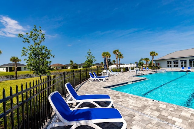 745 SE Bloomfield Rd, Port Saint Lucie, FL 34984 - community pool featuring a patio area and a residential view
