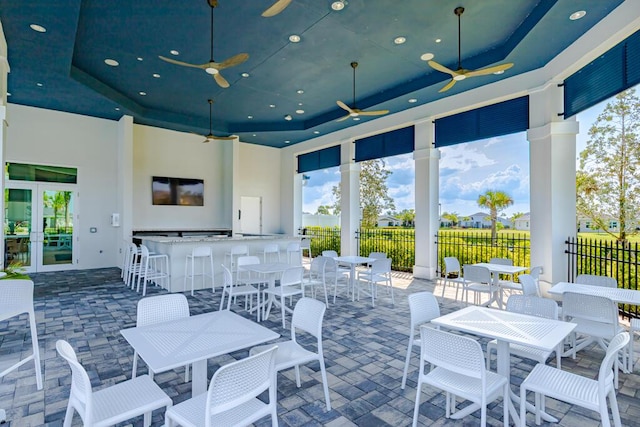 745 SE Bloomfield Rd, Port Saint Lucie, FL 34984 - view of patio / terrace featuring fence, exterior bar, outdoor dining space, and a ceiling fan