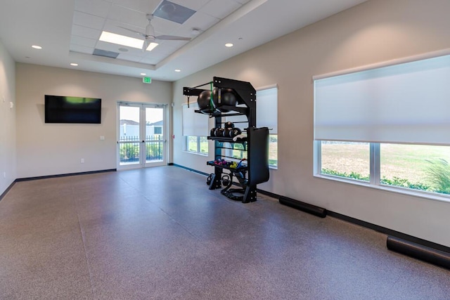 745 SE Bloomfield Rd, Port Saint Lucie, FL 34984 - workout room with baseboards, french doors, a ceiling fan, and a tray ceiling