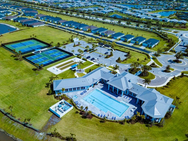 745 SE Bloomfield Rd, Port Saint Lucie, FL 34984 - aerial perspective of suburban area featuring a nearby body of water and a pool area